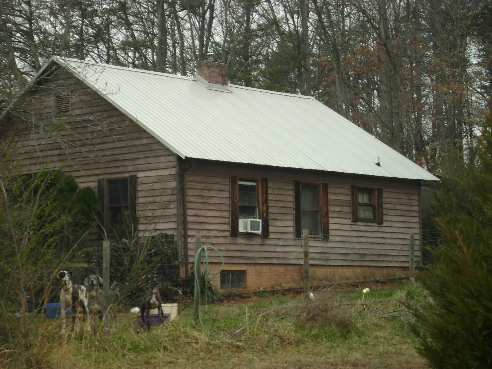 White metal roof on an old wood sided farmhouse, from a Metal Roof Installation job in Washington